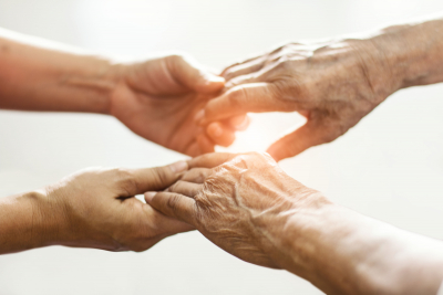 close up hands of helping hands elderly home care