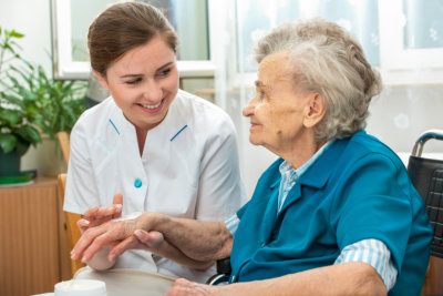 caregiver hold the hand of senior