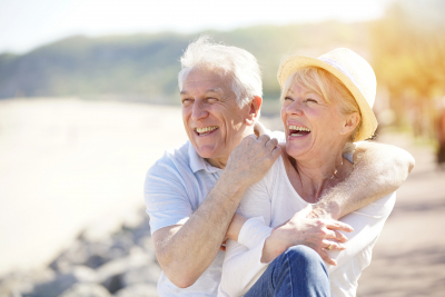 senior couple relaxing by the sea on sunny day