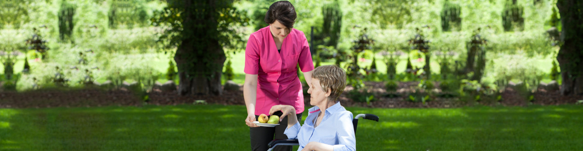 caregiver giving mango to senior woman